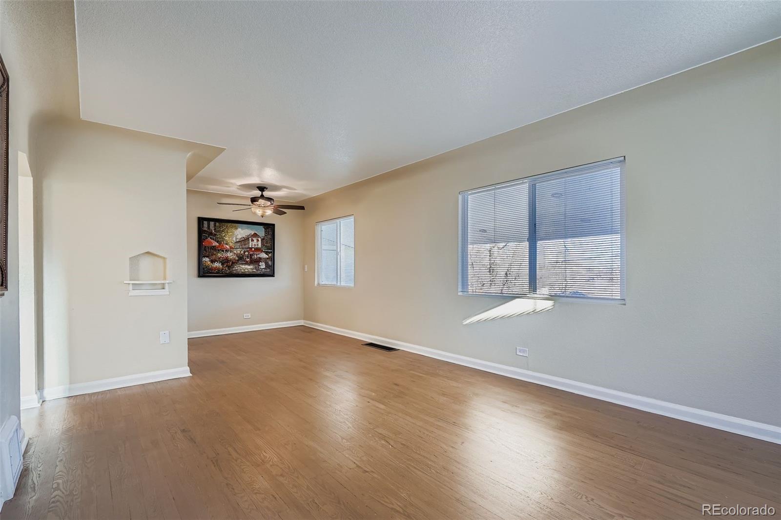 680 Irving Street Denver, CO 80204 - Photo 8 of 33 an empty room with windows and cabinet