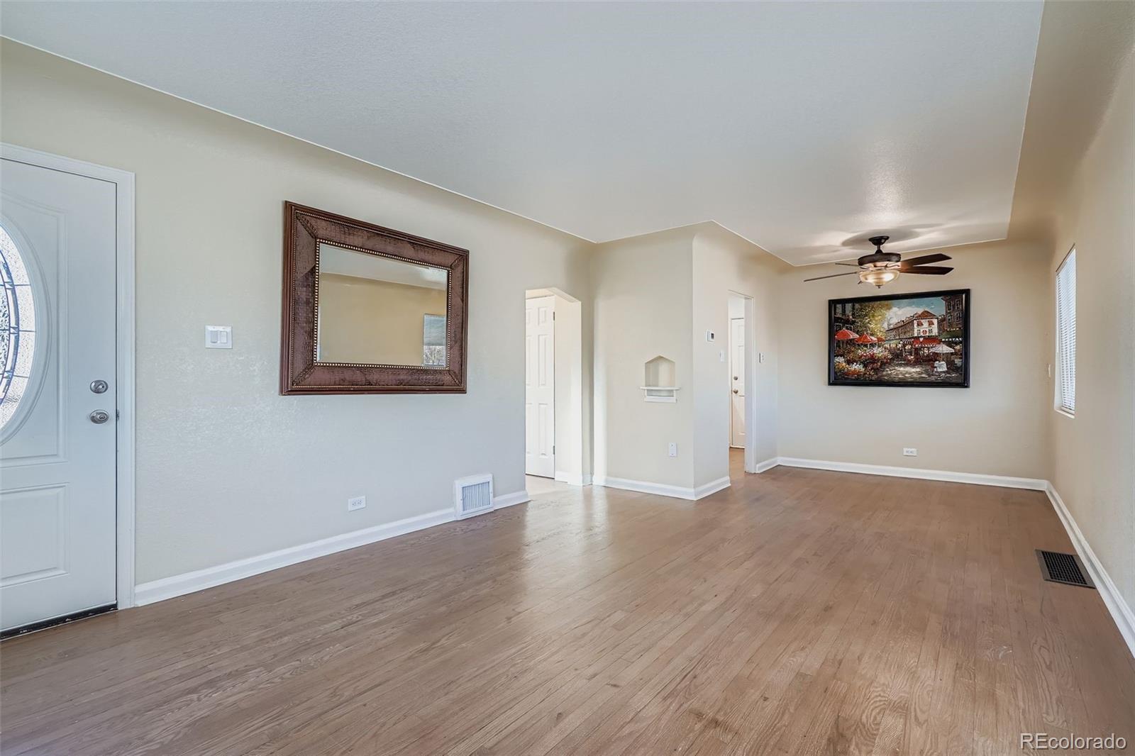 680 Irving Street Denver, CO 80204 - Photo 9 of 33 a view of an empty room with wooden floor and a window