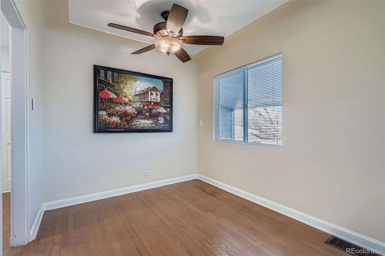 680 Irving Street Denver, CO 80204 - Photo 10 of 33 an empty room with wooden floor and windows