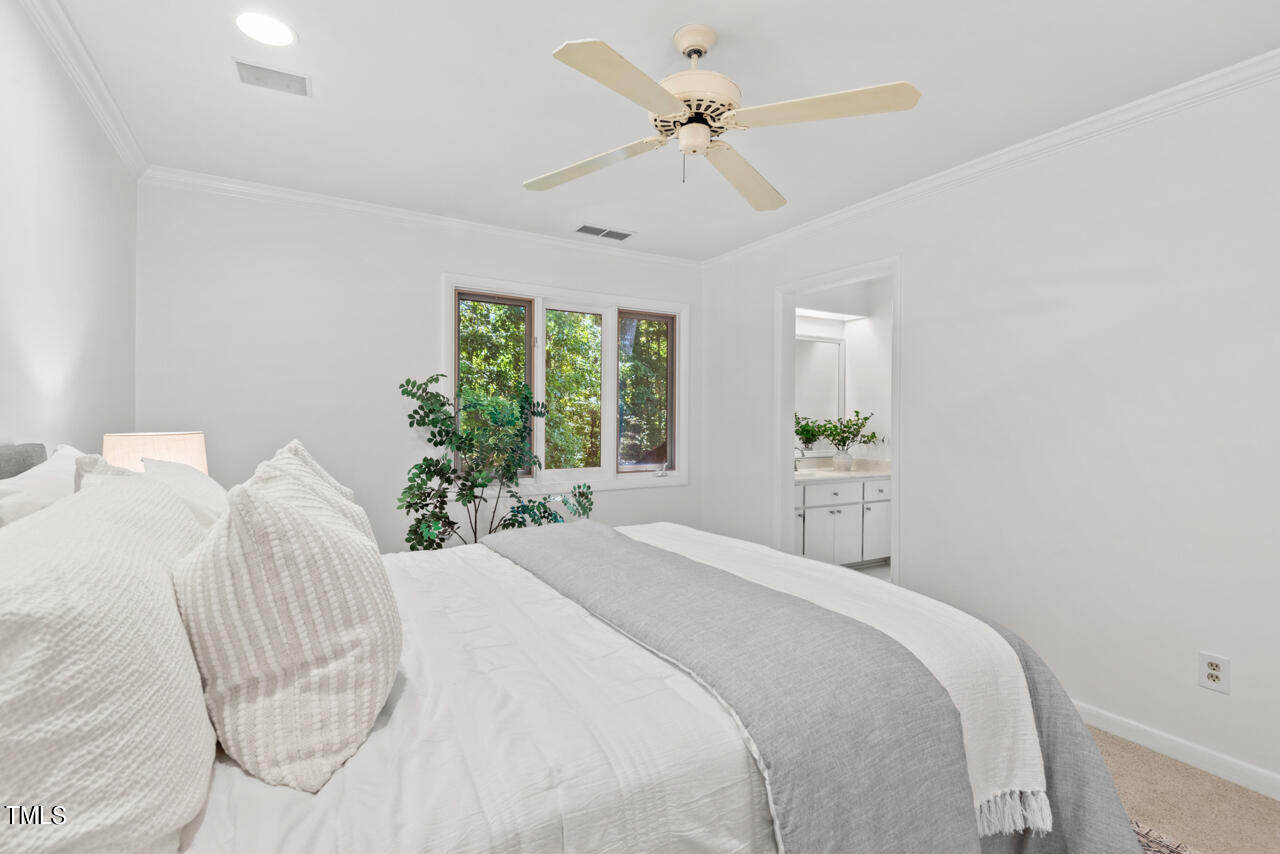 50 Stoneridge Road Durham, NC 27705 - Photo 26 of 40 a bedroom with a bed and a chandelier