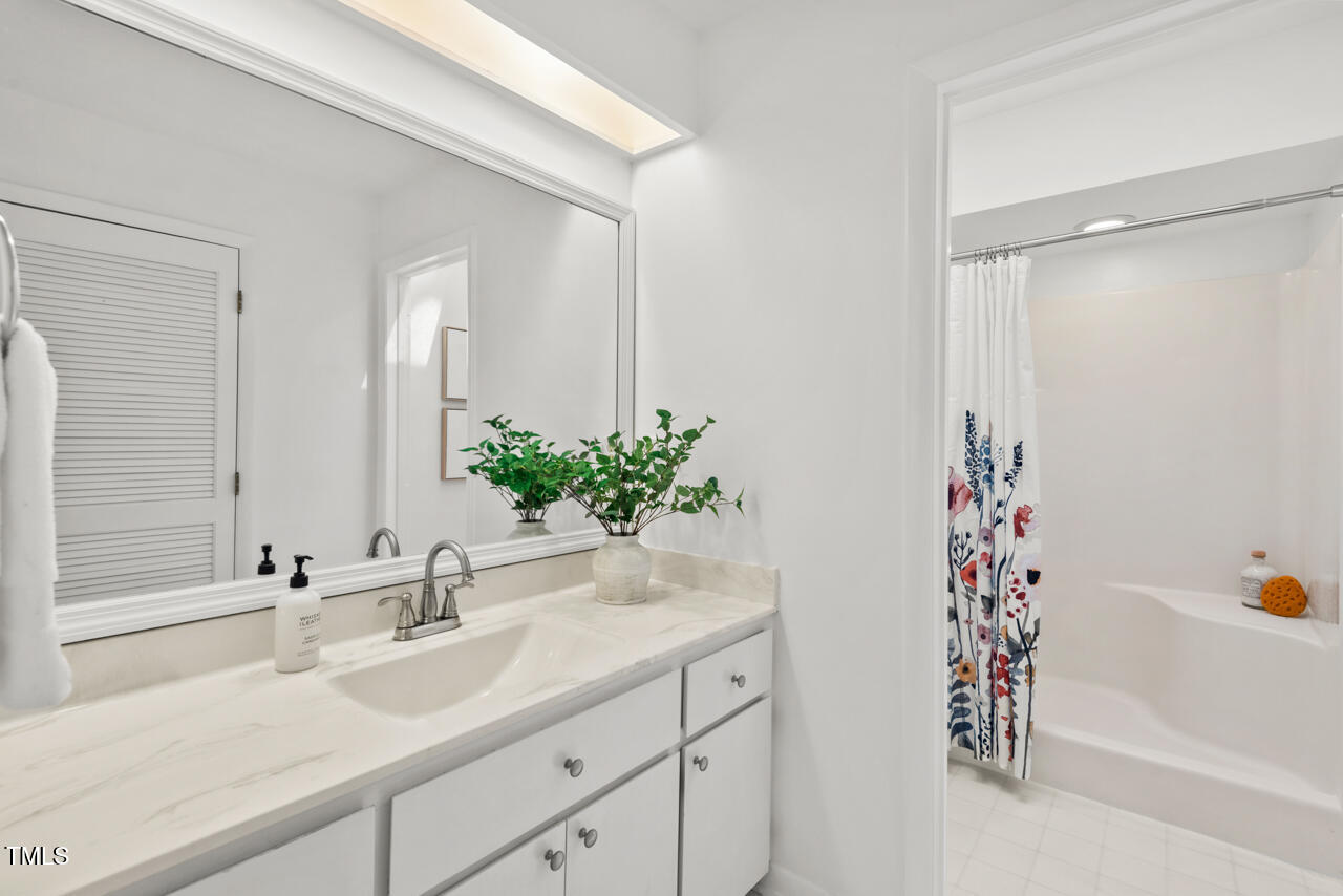 50 Stoneridge Road Durham, NC 27705 - Photo 28 of 40 a bathroom with a sink a vanity and a mirror