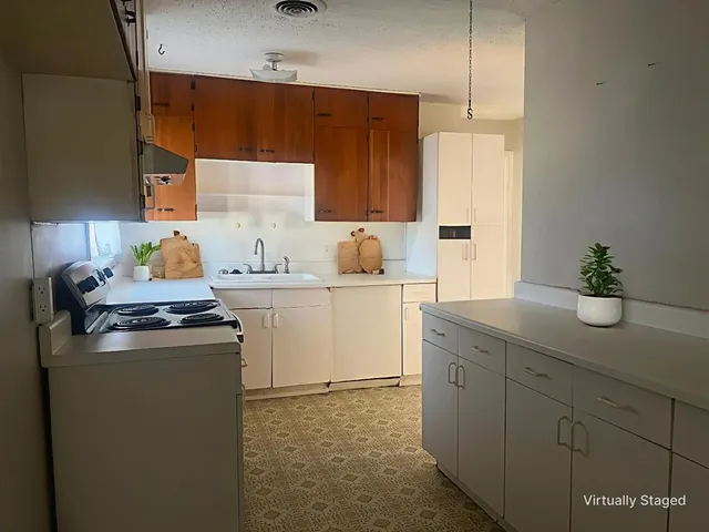 a kitchen with a stove and a sink
