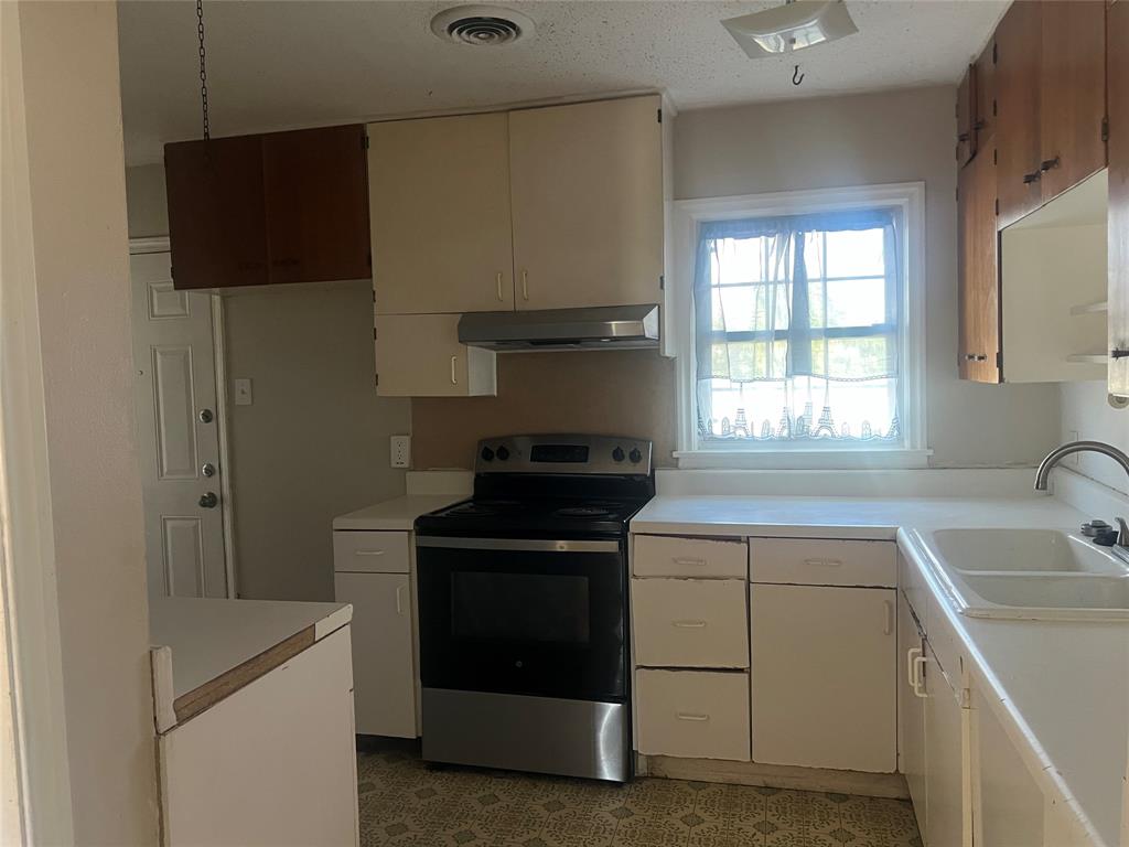 1721 Jocyle Street Arlington, TX 76010 - Photo 12 of 30 a kitchen with a stove and a sink