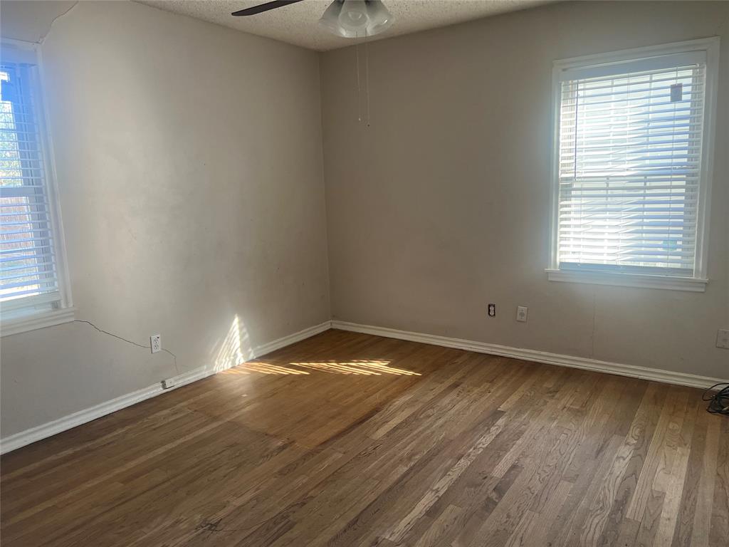 1721 Jocyle Street Arlington, TX 76010 - Photo 15 of 30 an empty room with wooden floor and windows