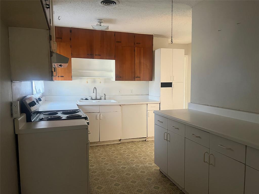 1721 Jocyle Street Arlington, TX 76010 - Photo 10 of 30 a kitchen with a sink stove and cabinets