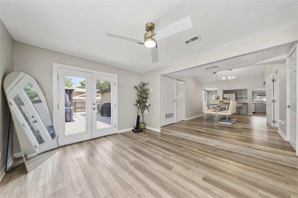 357 Ridgewood Street Altamonte Springs, FL 32701 - Photo 12 of 36 a view of a livingroom with wooden floor and a ceiling fan