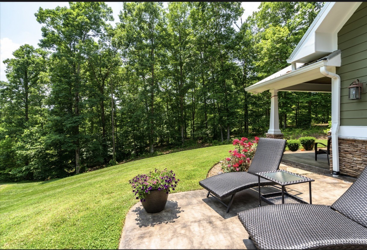 a wooden bench sitting in the backyard of a house
