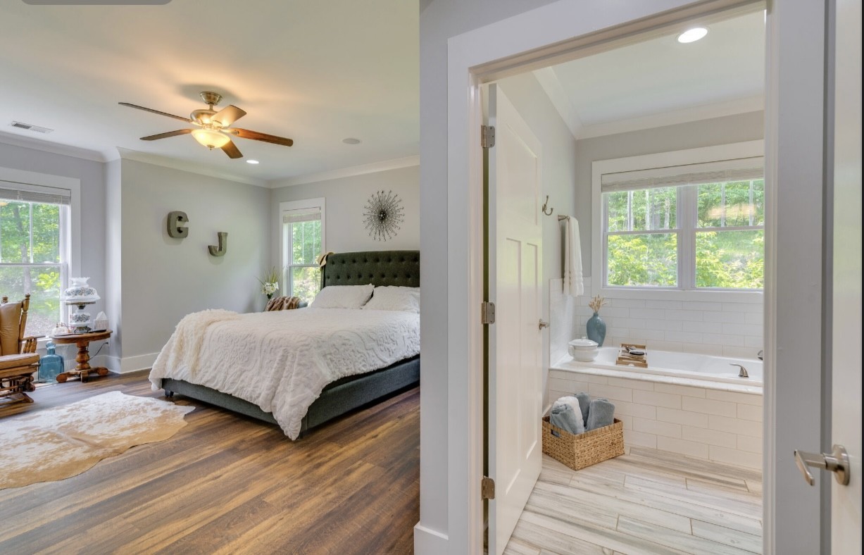 5560 Pinewood Road Franklin, TN 37064 - Photo 17 of 43 a bedroom with a large bed and a chandelier