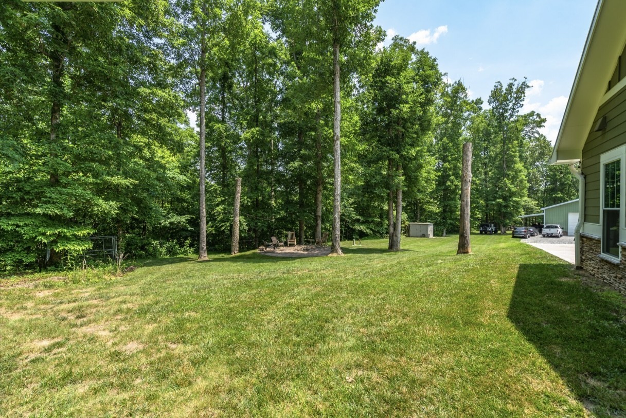 5560 Pinewood Road Franklin, TN 37064 - Photo 33 of 43 a view of a grassy field with trees in the background