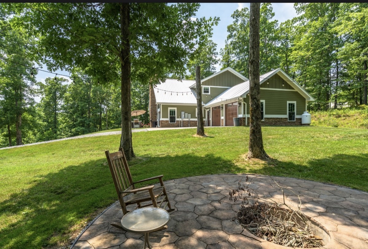 5560 Pinewood Road Franklin, TN 37064 - Photo 4 of 43 a backyard of a house with table and chairs