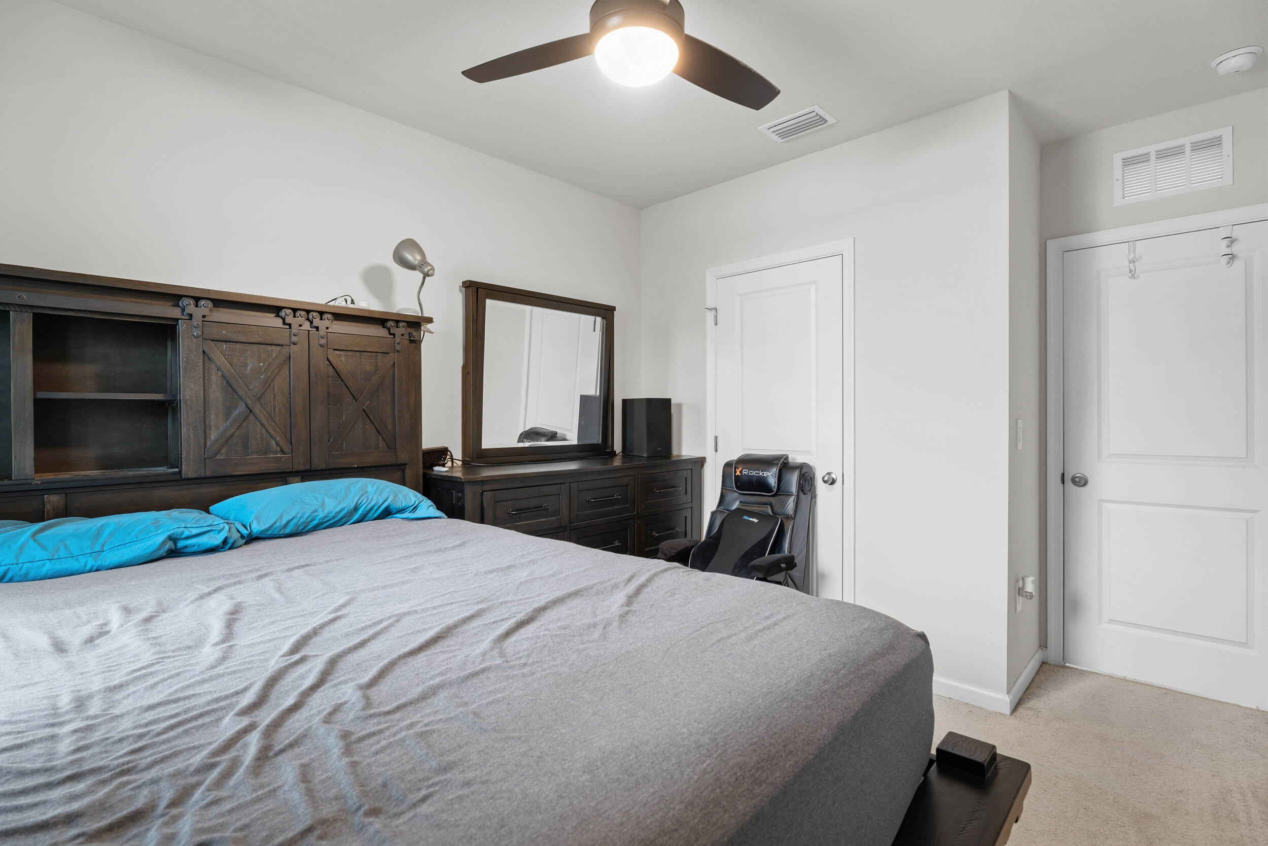 271 Raspberry Road Fort Pierce, FL 34981 - Photo 19 of 42 a bedroom with a large bed and a tv