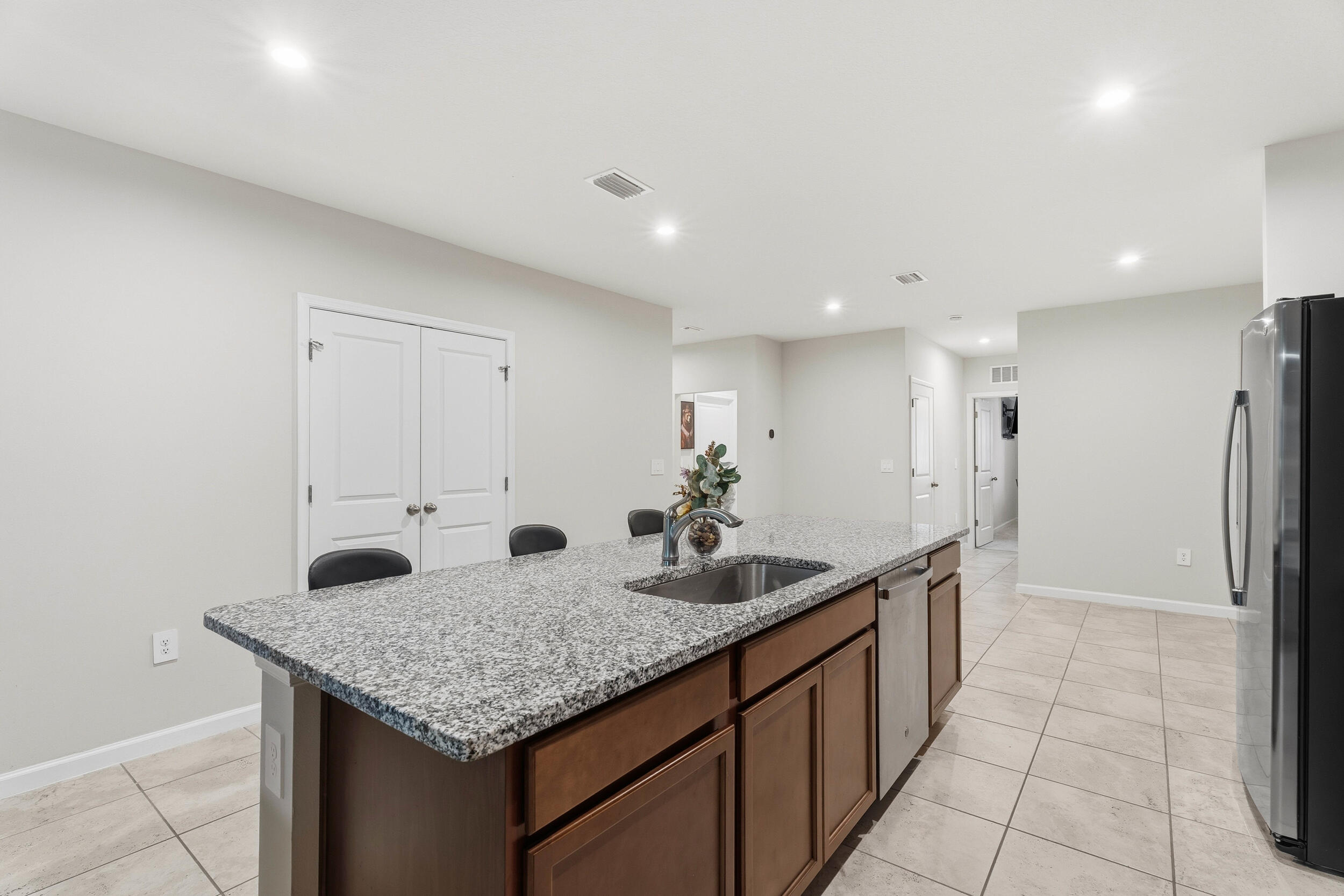 271 Raspberry Road Fort Pierce, FL 34981 - Photo 5 of 42 a kitchen with center island and a refrigerator