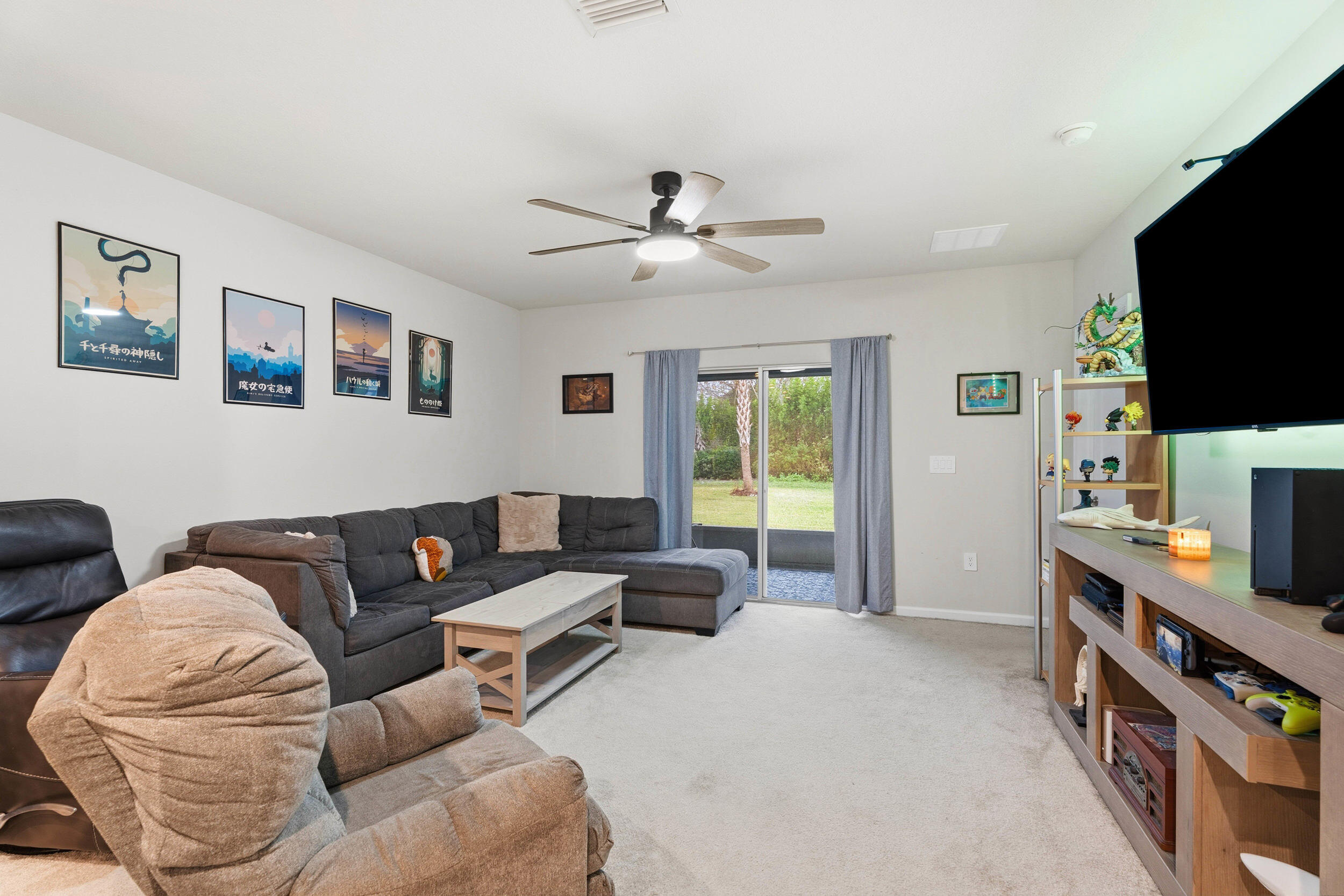 271 Raspberry Road Fort Pierce, FL 34981 - Photo 8 of 42 a living room with furniture and a flat screen tv