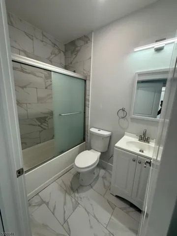 a bathroom with a toilet sink and shower