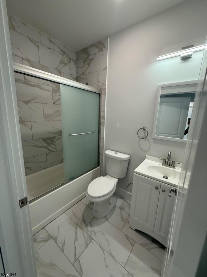 261 Marshall Street, Unit 507 Paterson, NJ 07503 - Photo 5 of 14 a bathroom with a toilet sink and shower