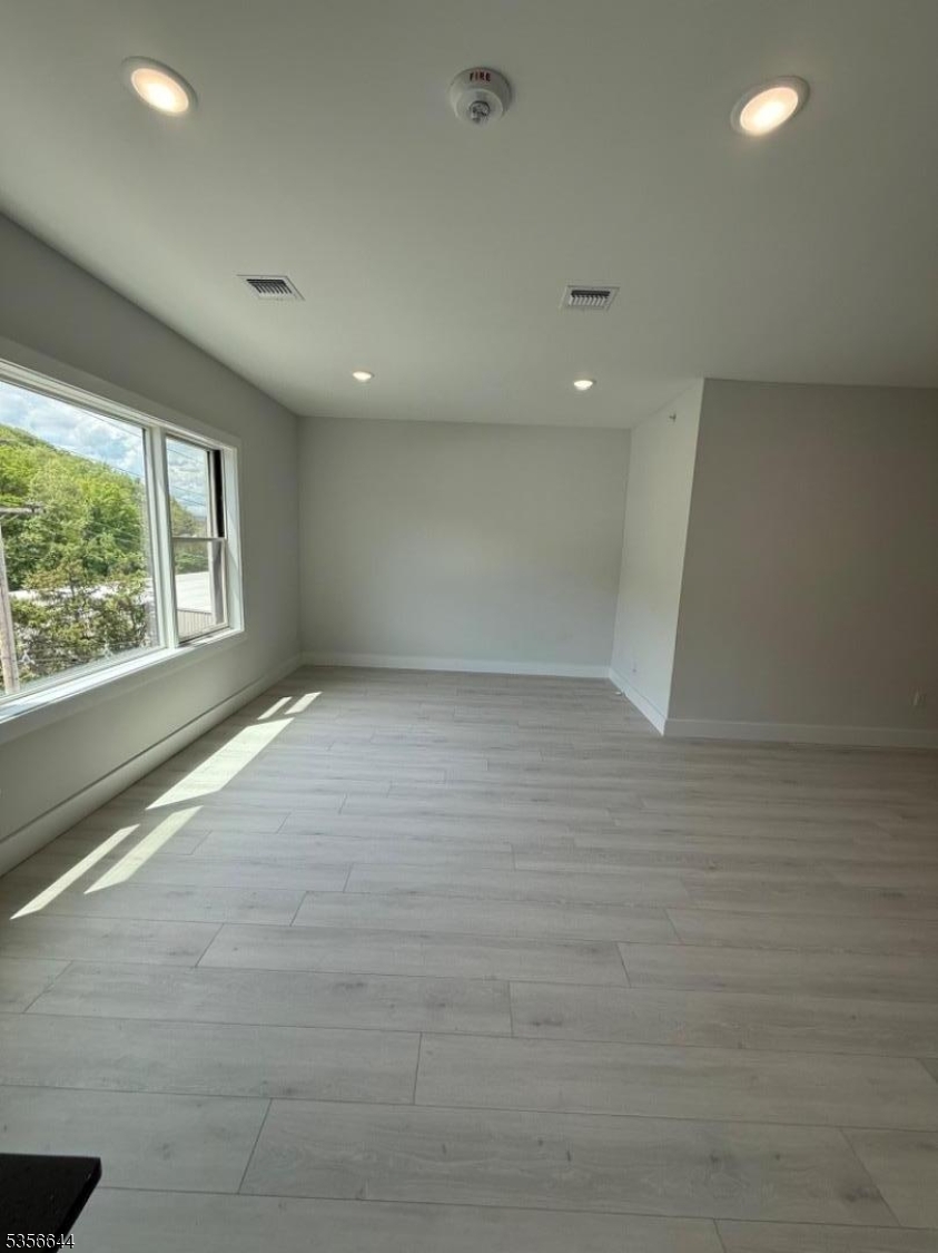 261 Marshall Street, Unit 507 Paterson, NJ 07503 - Photo 6 of 14 an empty room with windows