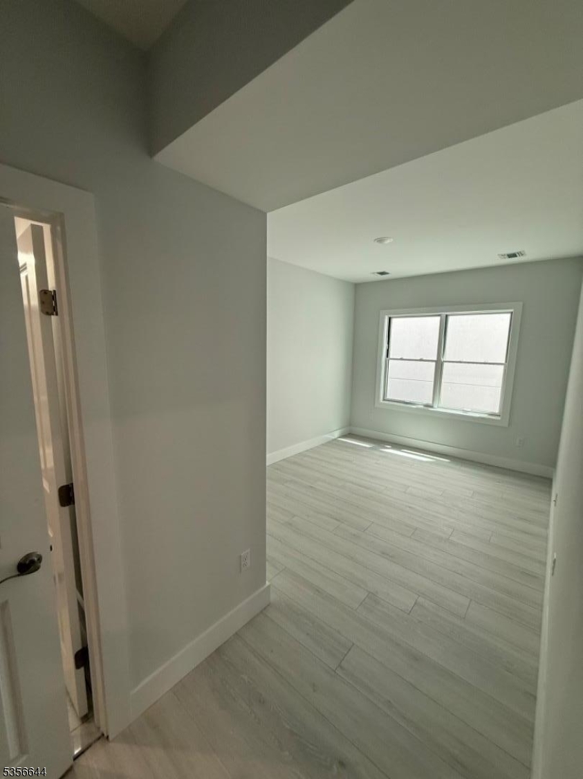 261 Marshall Street, Unit 507 Paterson, NJ 07503 - Photo 8 of 14 an empty room with windows