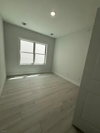 an empty room with a empty space and windows