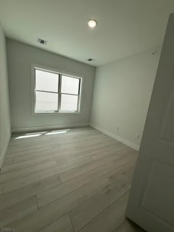 an empty room with a empty space and windows