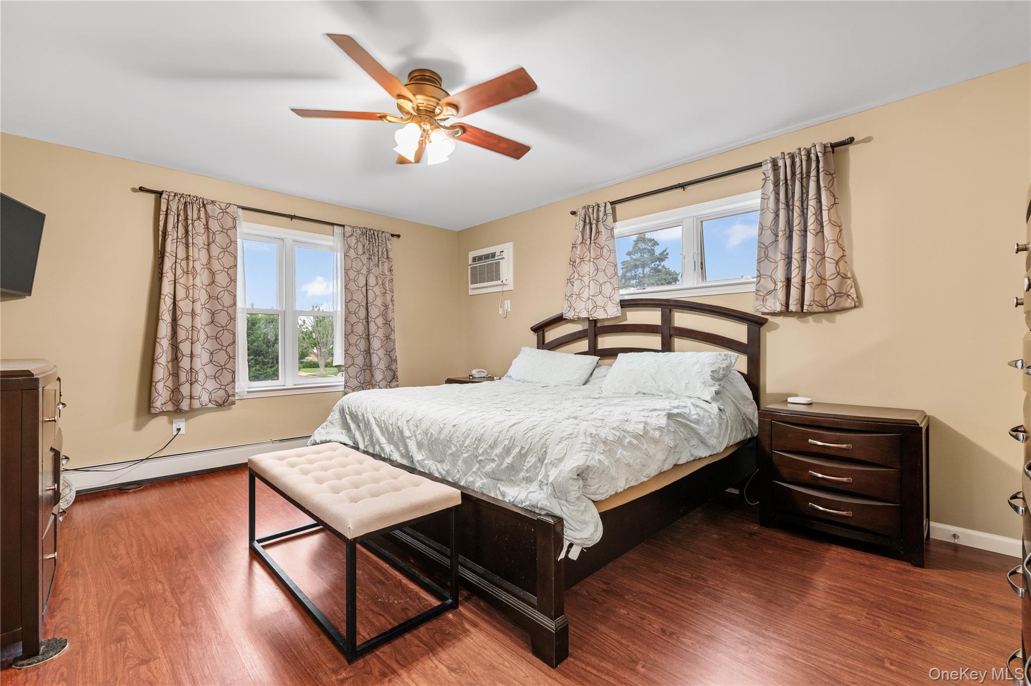 3 Cheshire Road Bethpage, NY 11714 - Photo 13 of 26 a bedroom with a bed window and a flat screen tv