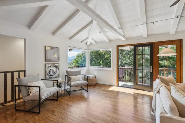 a view of roof deck with furniture and garden view
