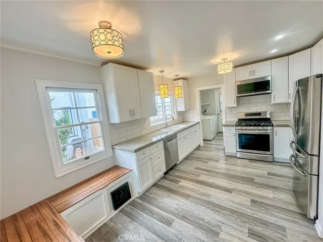 a large kitchen with stainless steel appliances granite countertop a stove and a sink