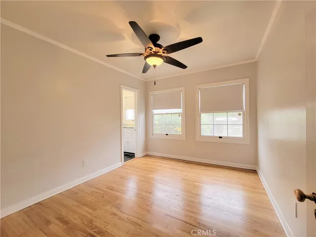 a view of a livingroom with a ceiling fan and wooden floor