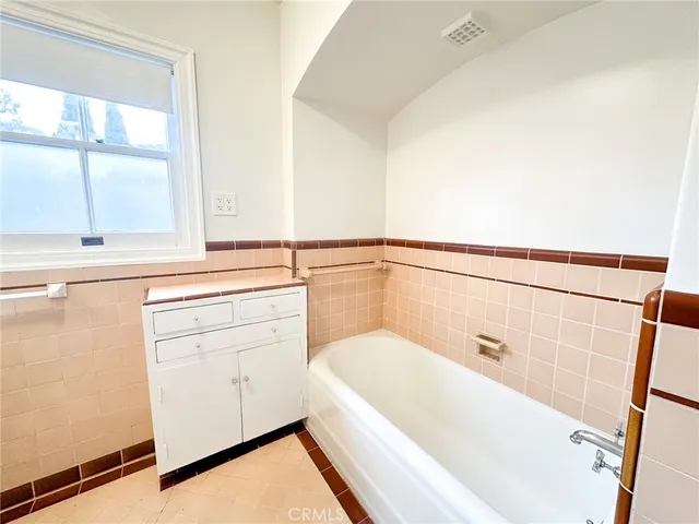 a bathroom with a bathtub and a window