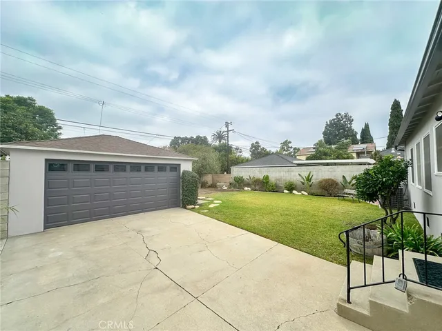 a front view of house with yard and car parked