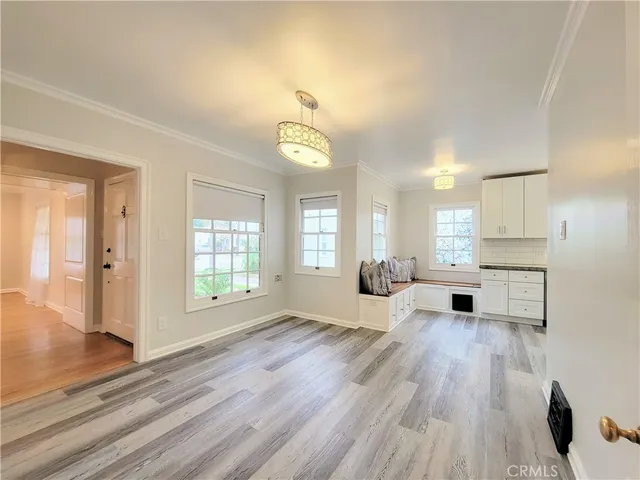 a living room with furniture stove and wooden floor