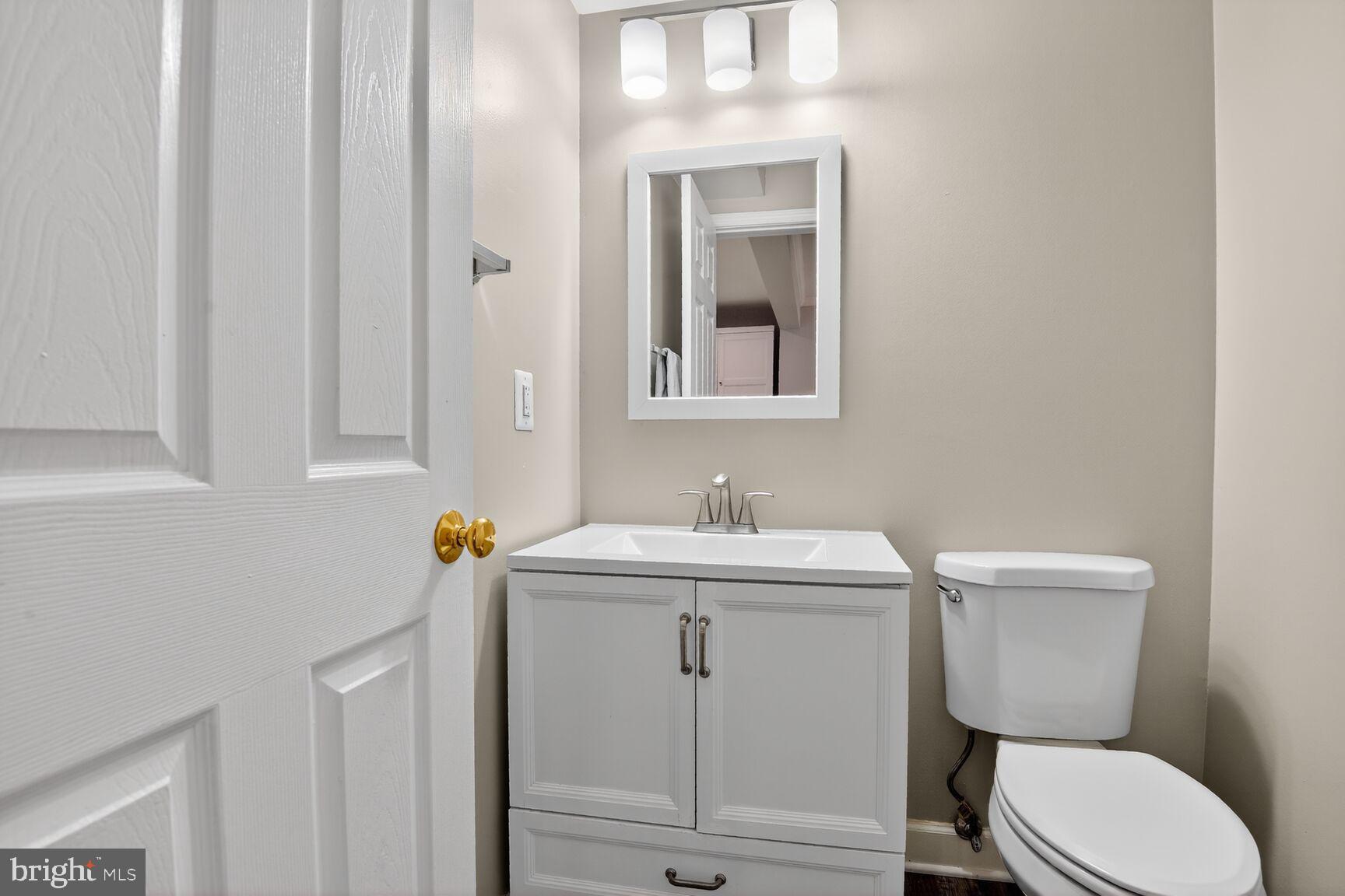 300 Center Lane Occoquan, VA 22125 - Photo 28 of 50 a bathroom with a toilet sink vanity and mirror