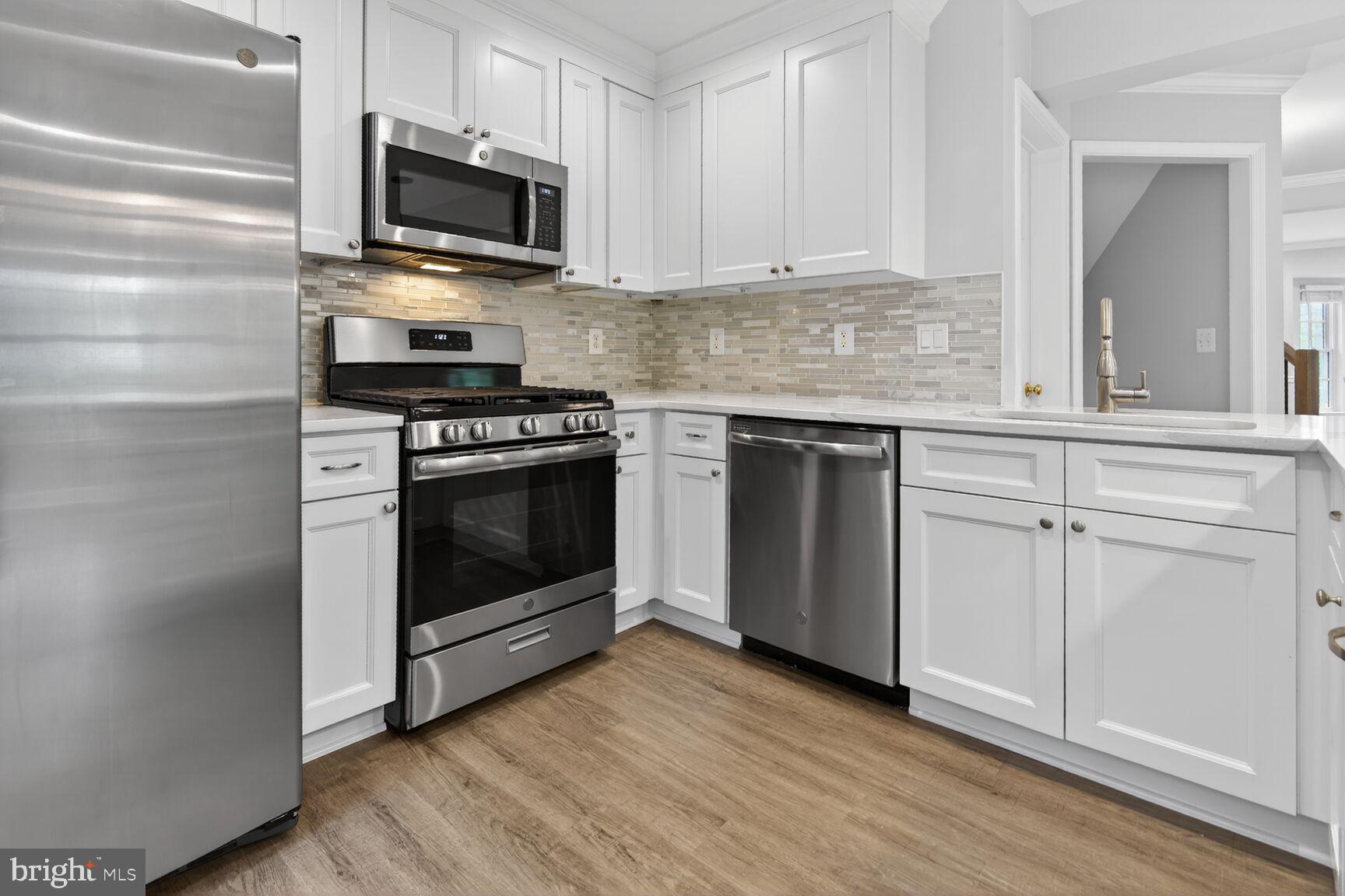 300 Center Lane Occoquan, VA 22125 - Photo 7 of 50 a kitchen with cabinets stainless steel appliances and wooden floor
