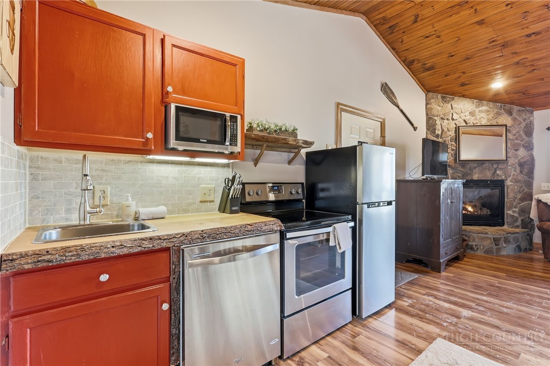 140 Lindale Ridge, Unit 504 Boone, NC 28607 - Photo 6 of 15 a kitchen with stainless steel appliances granite countertop a refrigerator stove and sink