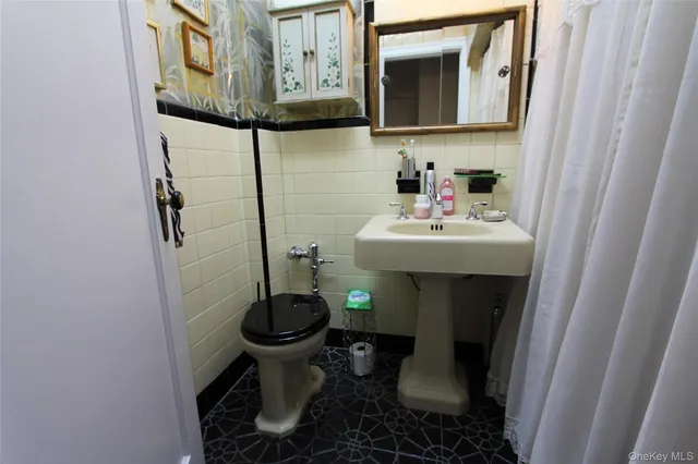 a bathroom with a sink toilet and mirror