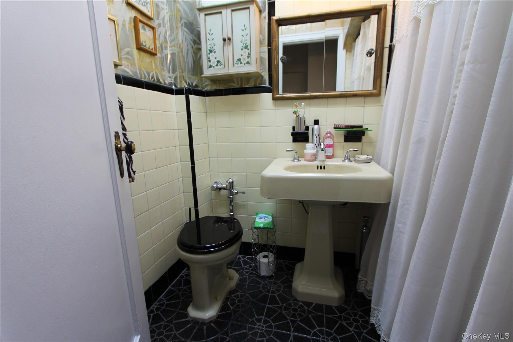 133-28 86th Street Queens, NY 11417 - Photo 8 of 17 a bathroom with a sink toilet and mirror