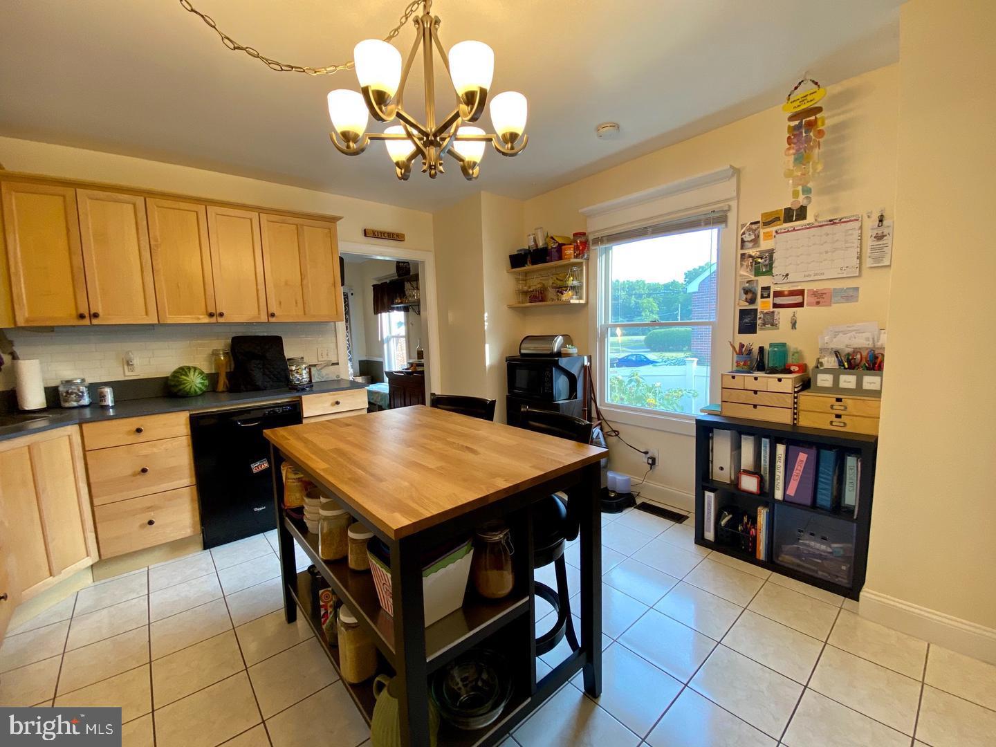 176 Moser Road Pottstown, PA 19464 - Photo 6 of 14 a kitchen with a stove a refrigerator and a dining table with wooden floor