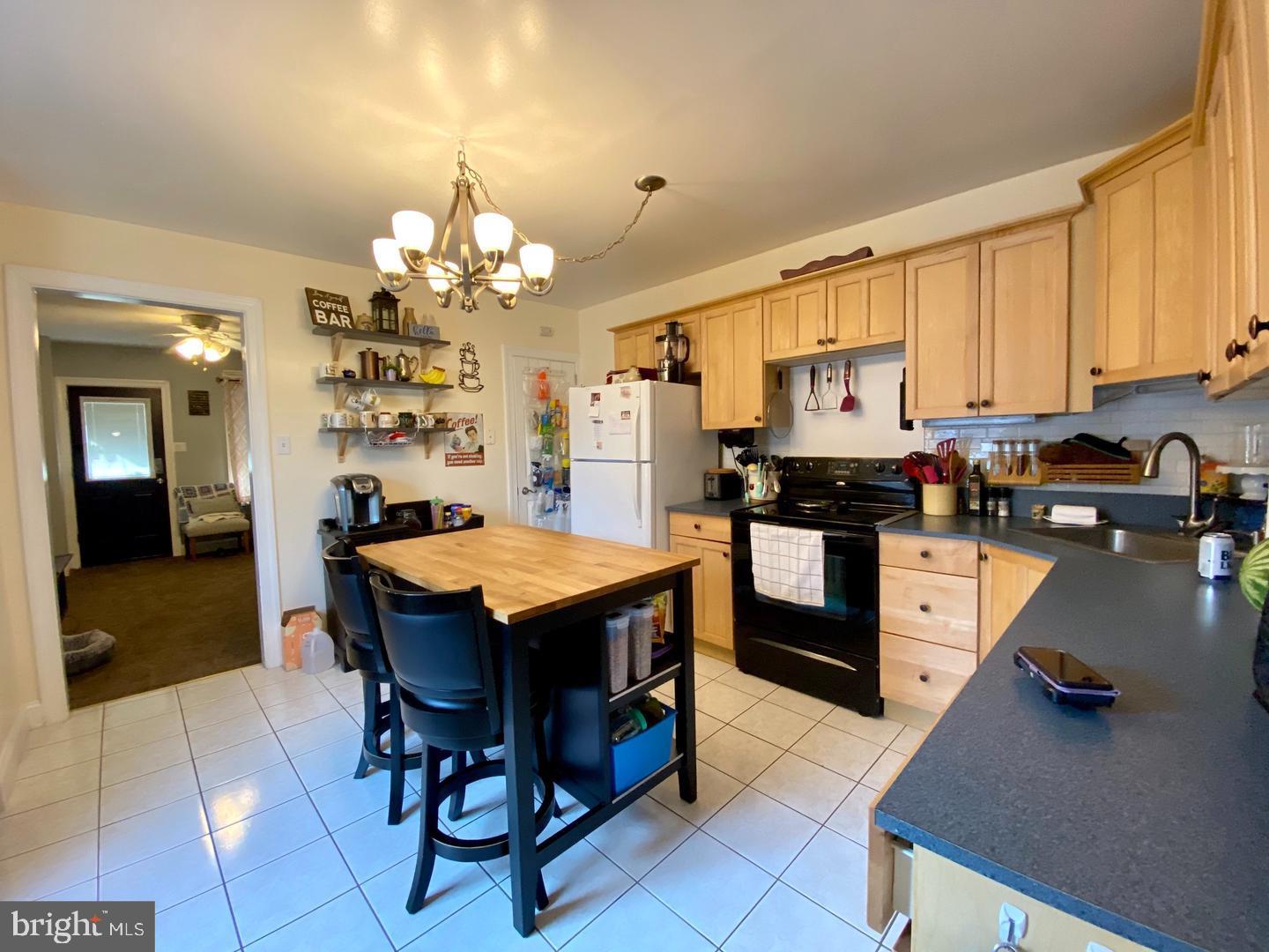 176 Moser Road Pottstown, PA 19464 - Photo 9 of 14 a kitchen with a table chairs refrigerator and cabinets