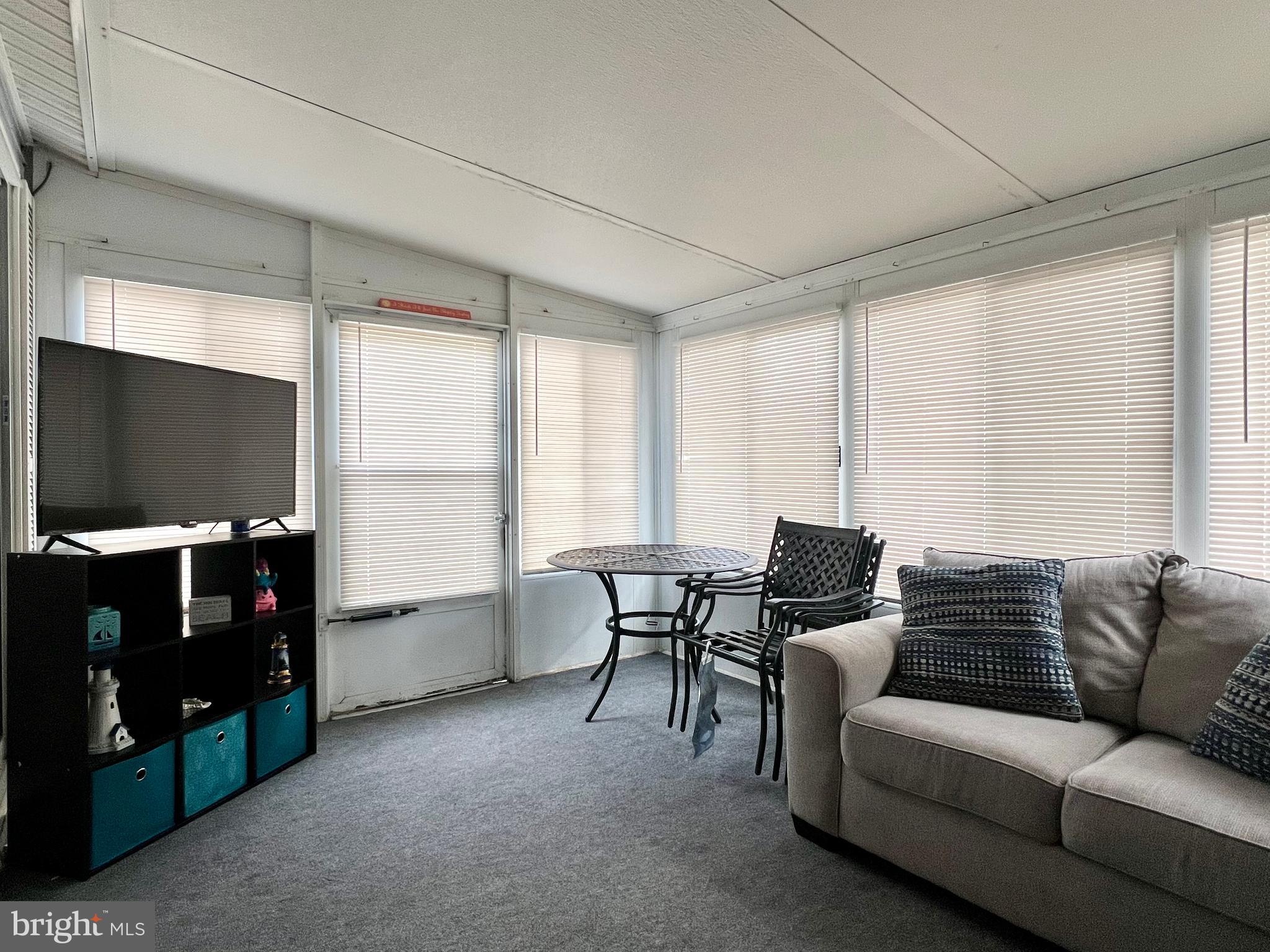 709 Seashore Road, Unit 626 Cape May, NJ 08204 - Photo 6 of 29 a living room with furniture and a flat screen tv