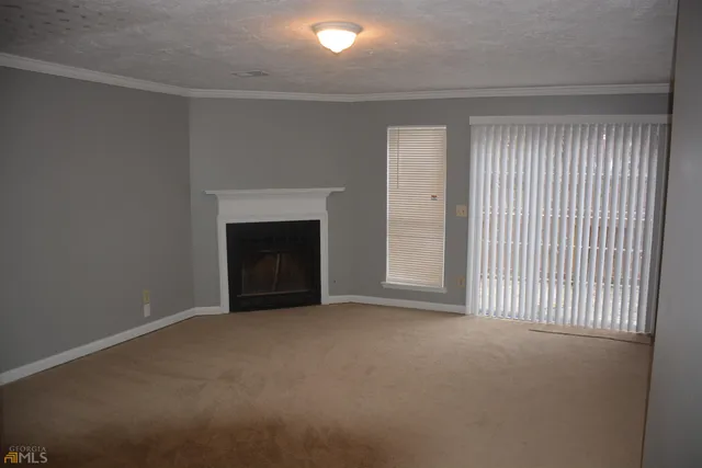 a view of an empty room with a fireplace