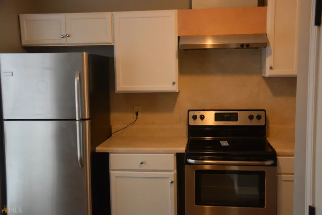 a kitchen with a stove and a refrigerator
