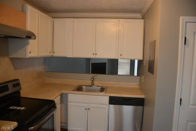 a kitchen with a sink and cabinets