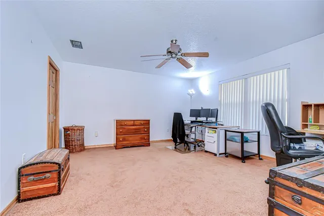 a view of a livingroom with furniture and a ceiling fan