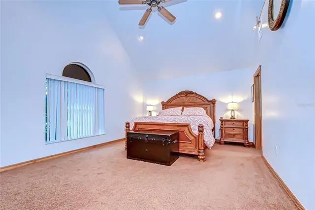 a bedroom with a bed and a painting on the wall