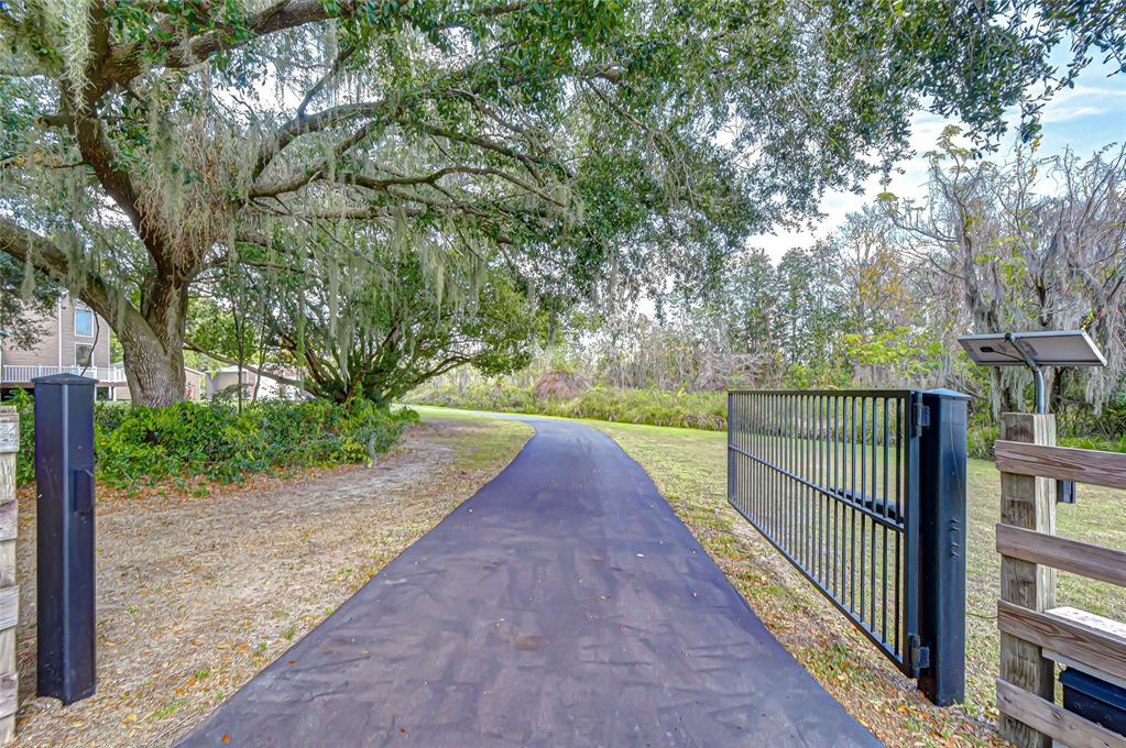 3719 Moores Lake Road Dover, FL 33527 - Photo 26 of 29 a view of a pathway with a wrought fence
