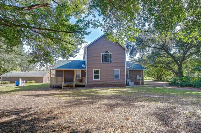 a house that has a tree in front of it
