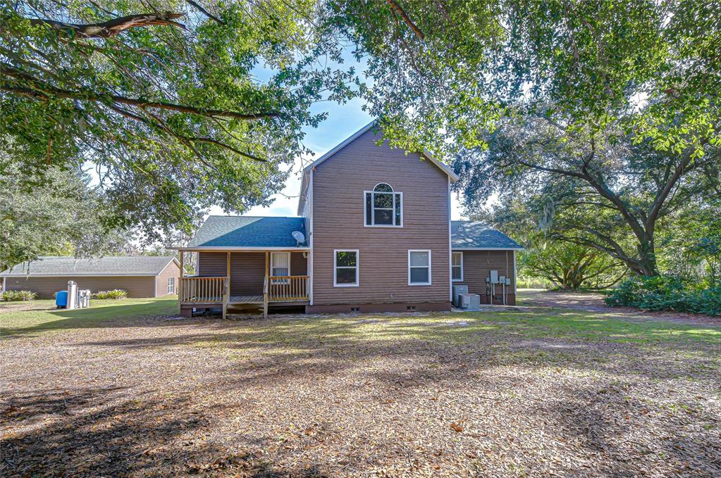 3719 Moores Lake Road Dover, FL 33527 - Photo 5 of 29 a house that has a tree in front of it