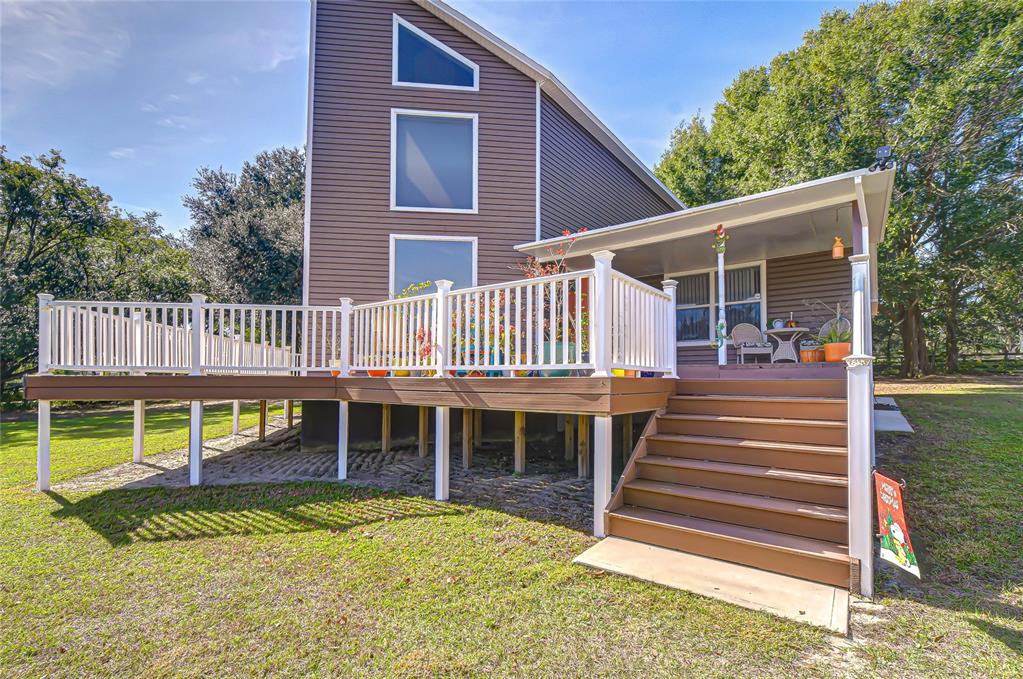 3719 Moores Lake Road Dover, FL 33527 - Photo 6 of 29 a view of a house with a yard deck and a large tree