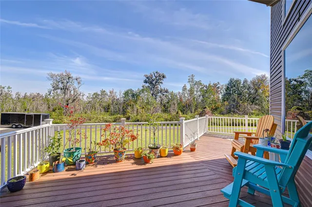 a view of a balcony with lake view and wooden floor