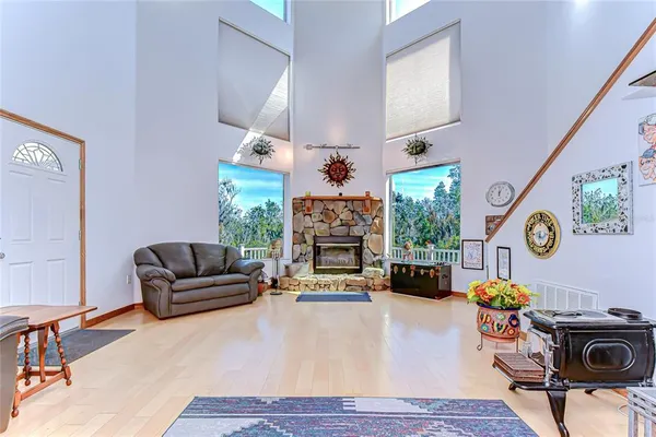 a living room with fireplace furniture and a window