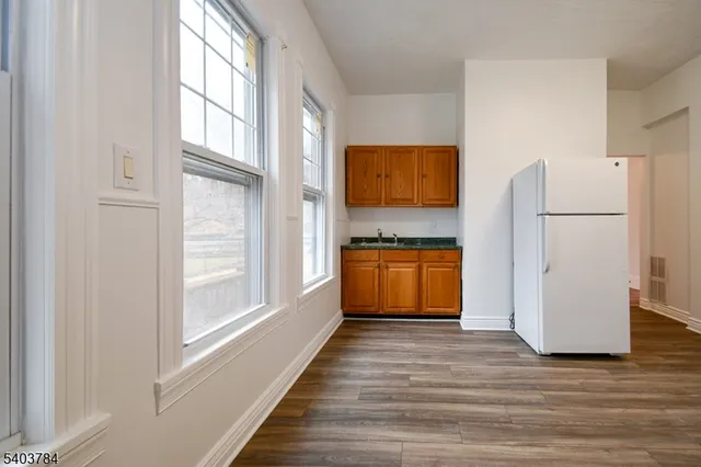 a room with a refrigerator and a stove top oven